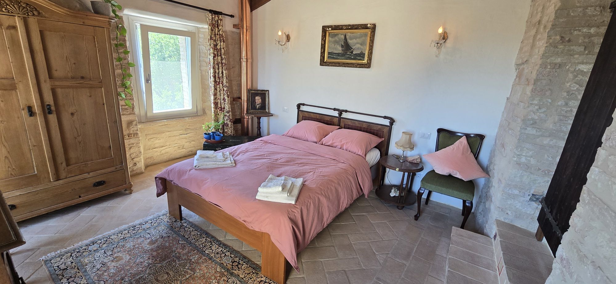 The View — the bedroom with its double bed and antique wardrobe