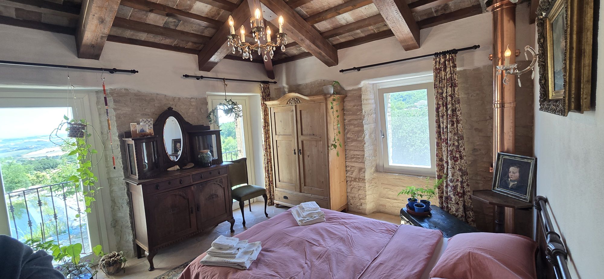 The View — chandelier, beamed ceiling and the valley through the window